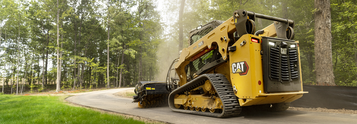 A Cat machine brushing the road clean