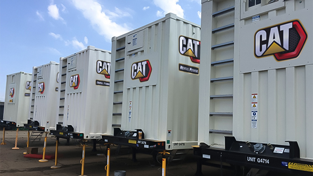 cat-rental-generators (1) black and white photo of CAT trailers lined up