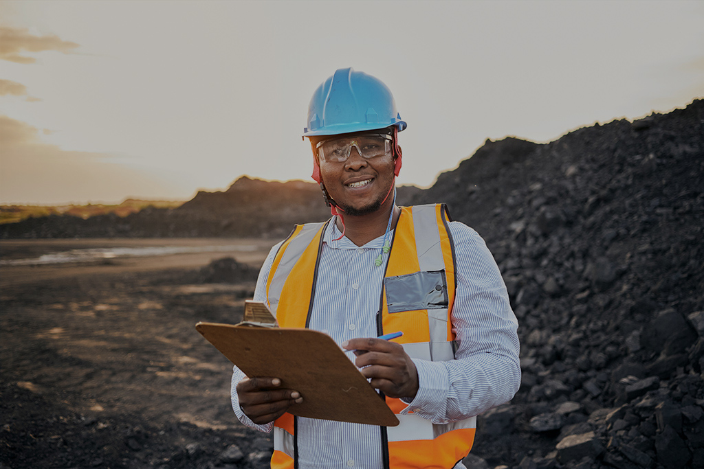 Construction worker smiling with a clipboard