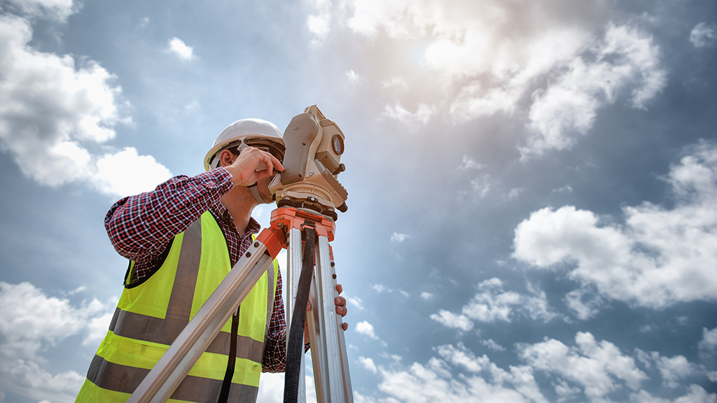 Worker inspecting construction site through a lens mechanism 