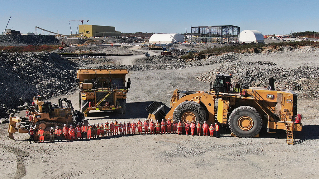 miningsolutions-timeline-3 Workers on a construction site lined up for a photo