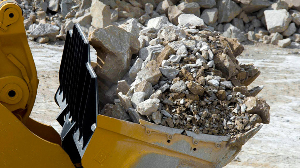 miningsolutions-timeline-4 Close up of a cat bulldozer transporting rocks