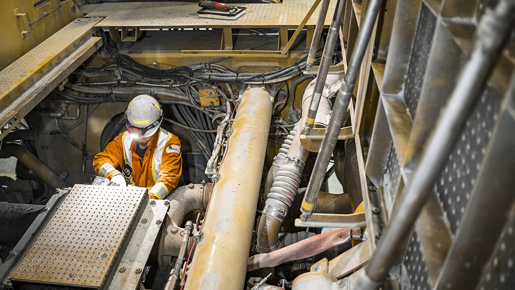miningsolutions-timeline-5a A construction worker repairing machinery