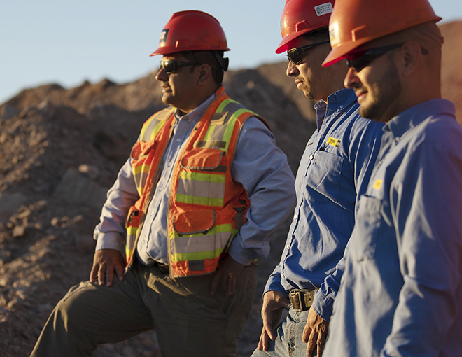 miningsolutions-cta1 Workers smiling and looking towards the sun on a construction site