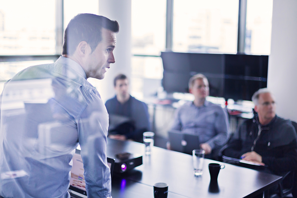 Employees viewing a presentation in a conference room 