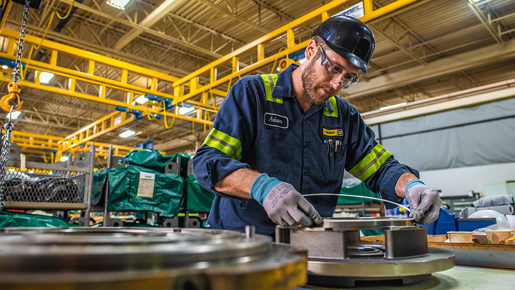 Construction worker measuring material in a warehouse