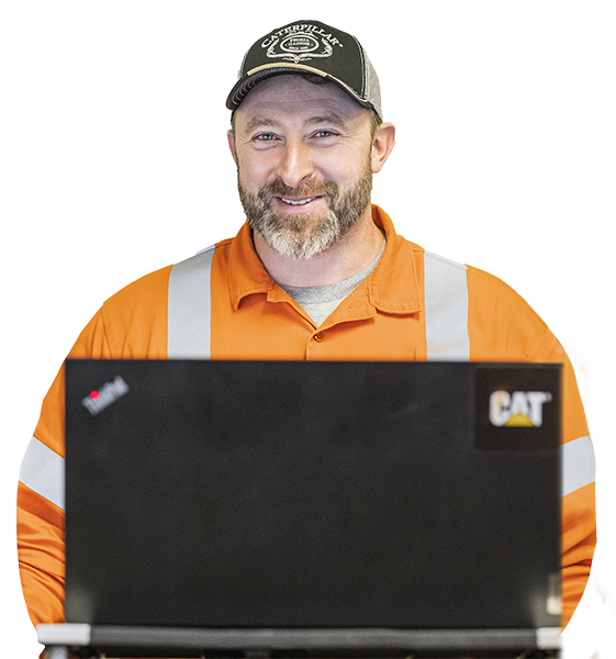 Worker smiling at camera behind a laptop
