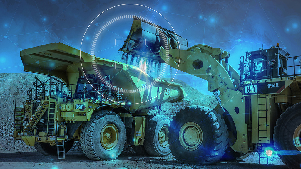 productivity-CAT_793NextGen_00167-2 Bulldozer transporting dirt onto a truck background image