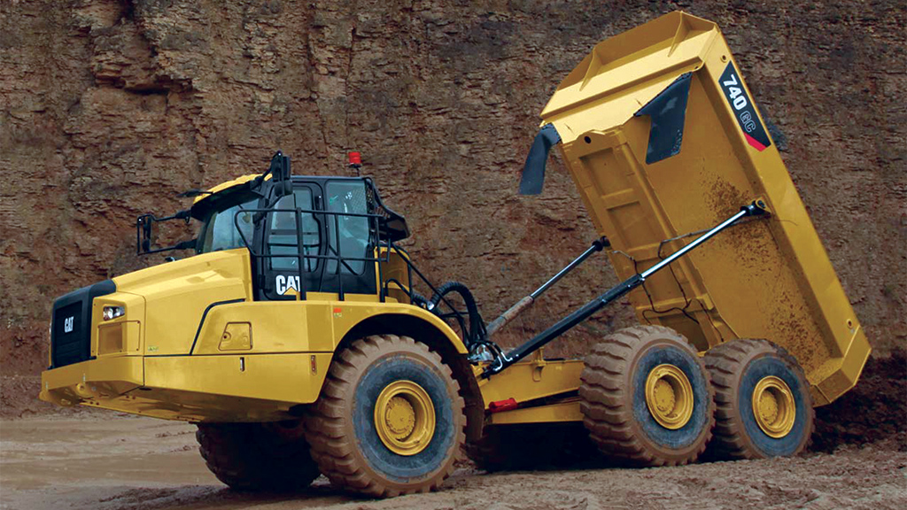 surface-equipment-articulatedtrucks Large cat truck dumping dirt