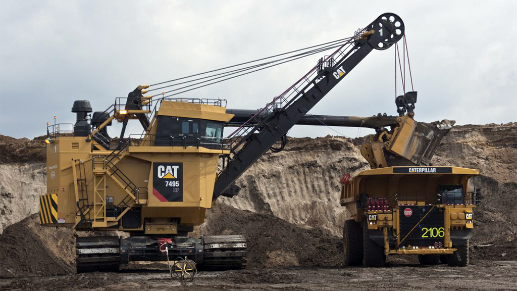 surface-equipment-electricropeshovels Cat truck dumping dirt into another transporting truck