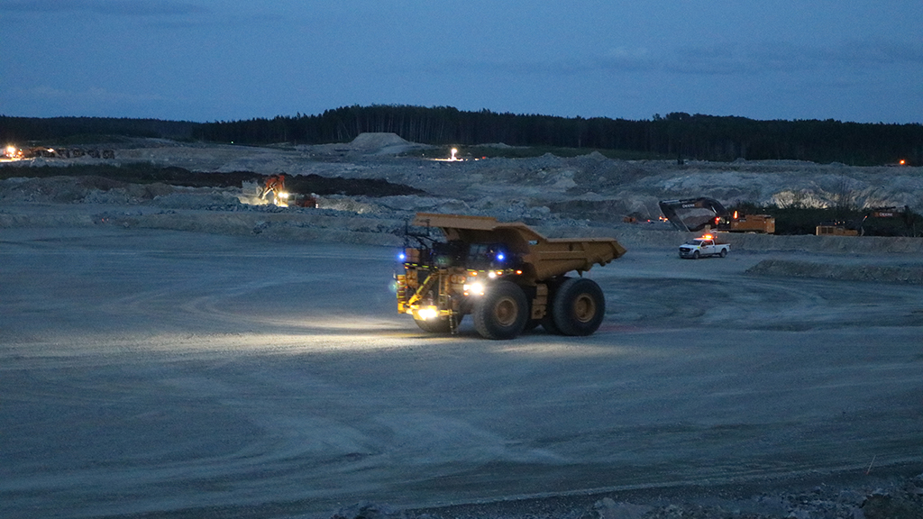 A cat transport truck driving at night 