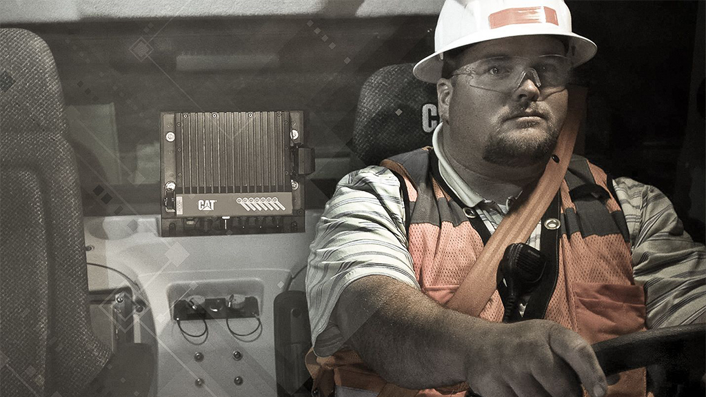 Worker driving a cat machine 