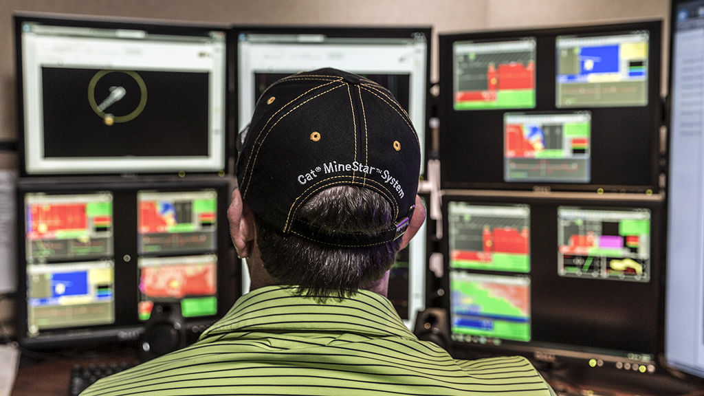 Worker analyzing data on screens 