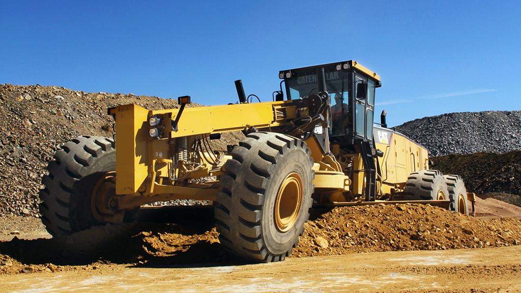 cat machine smoothing ground on site 