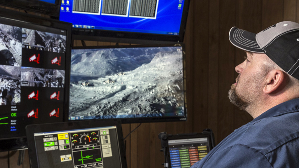 worker analyzing data on screens 