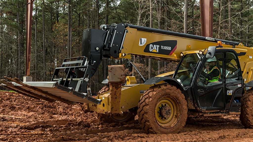 surface-equipment-telehandler Large cat machine transporting materials in the forest