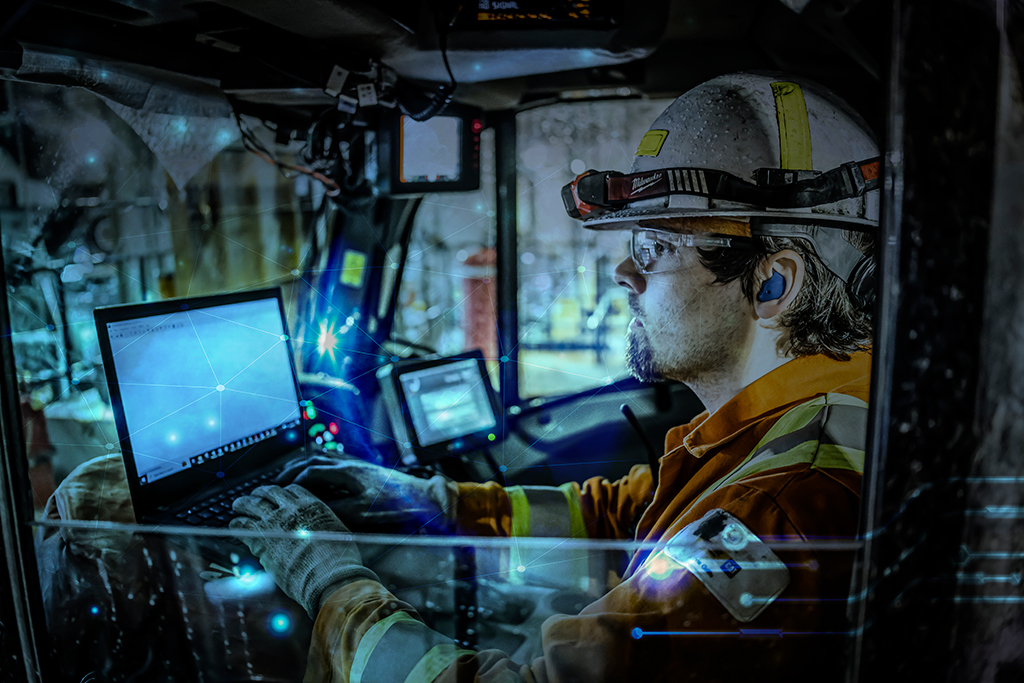 Worker using a laptop in a truck