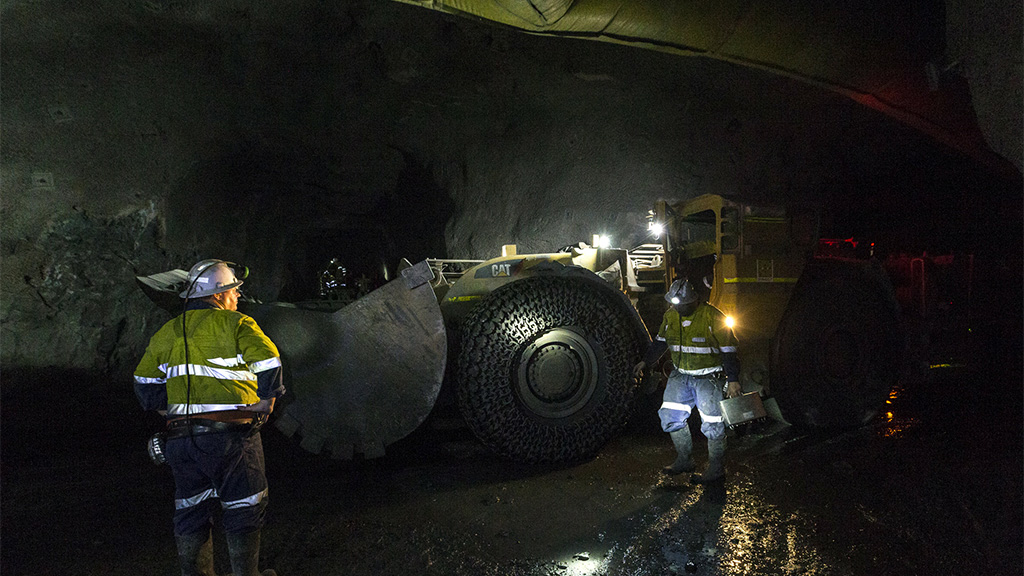 Workers underground with a bulldozer