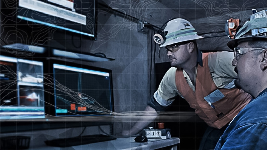 two workers looking at data on a screen 
